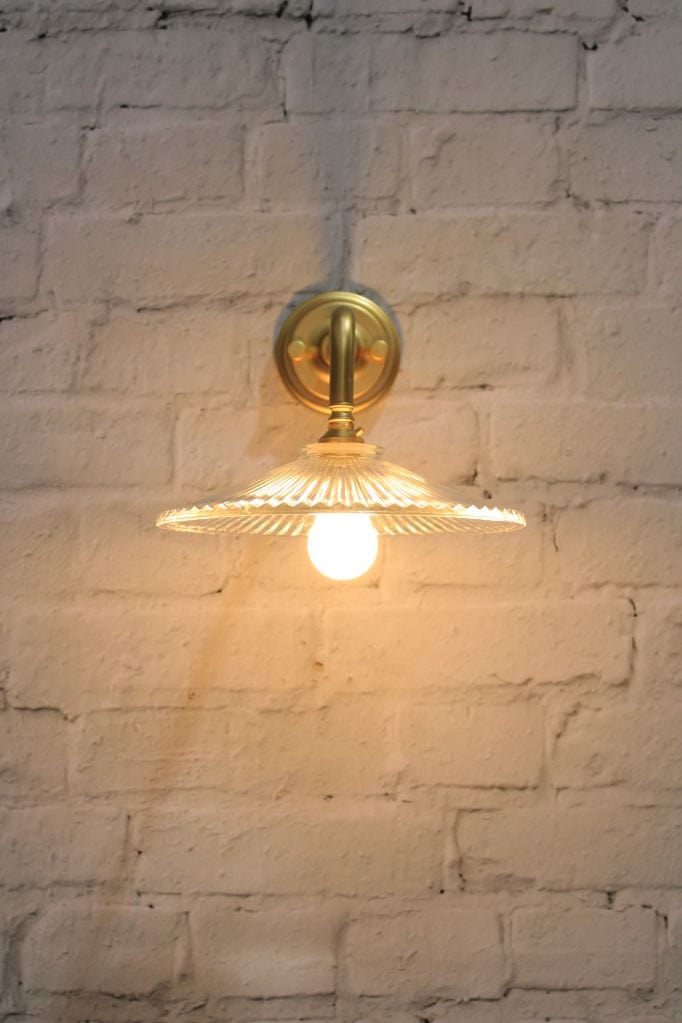 Glass wall light with gold/brass wall sconce