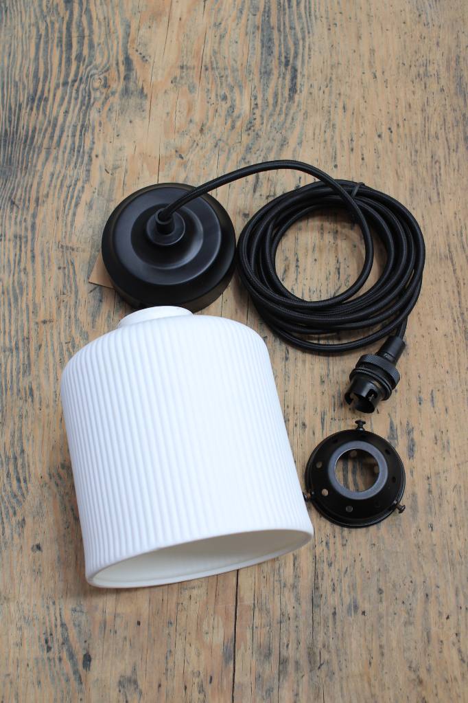 Ribbed ceramic shade with black cord and gallery