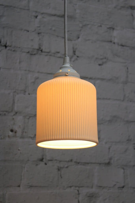 Ribbed ceramic pendant light with white gallery