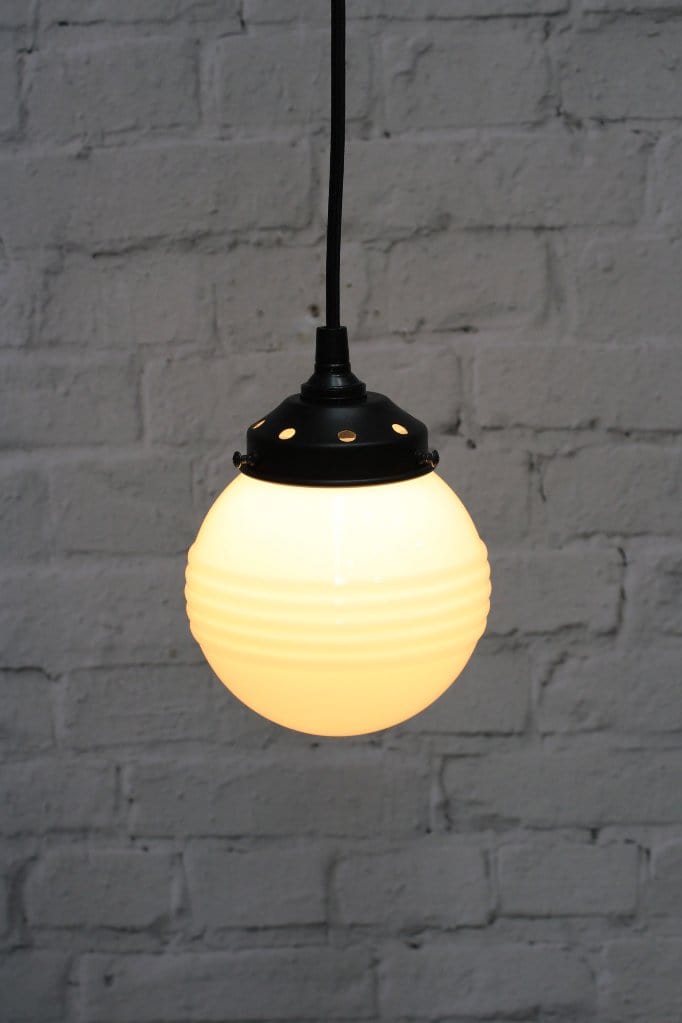 Pendant light with ridged opal glass shade and black round cord