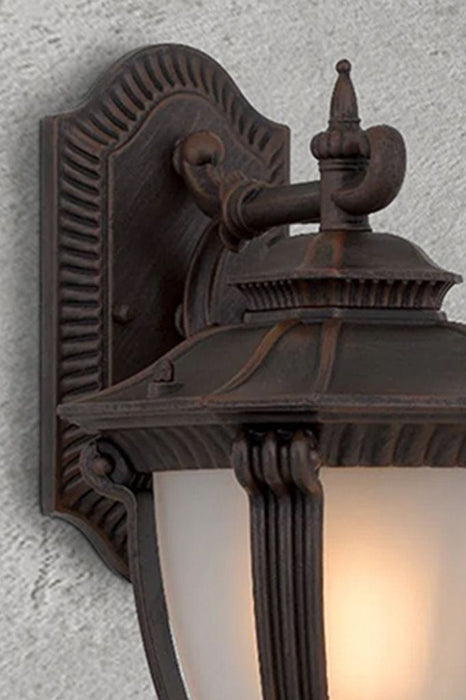 Close-up of outdoor wall light in antique bronze finish. 