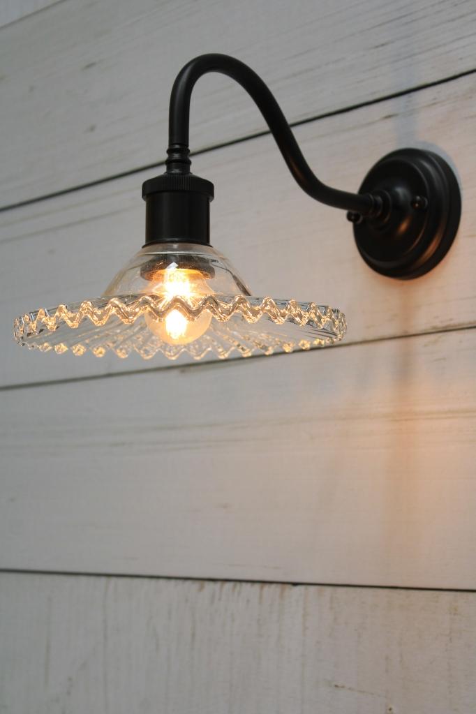 Scalloped glass wall light with black gooseneck arm