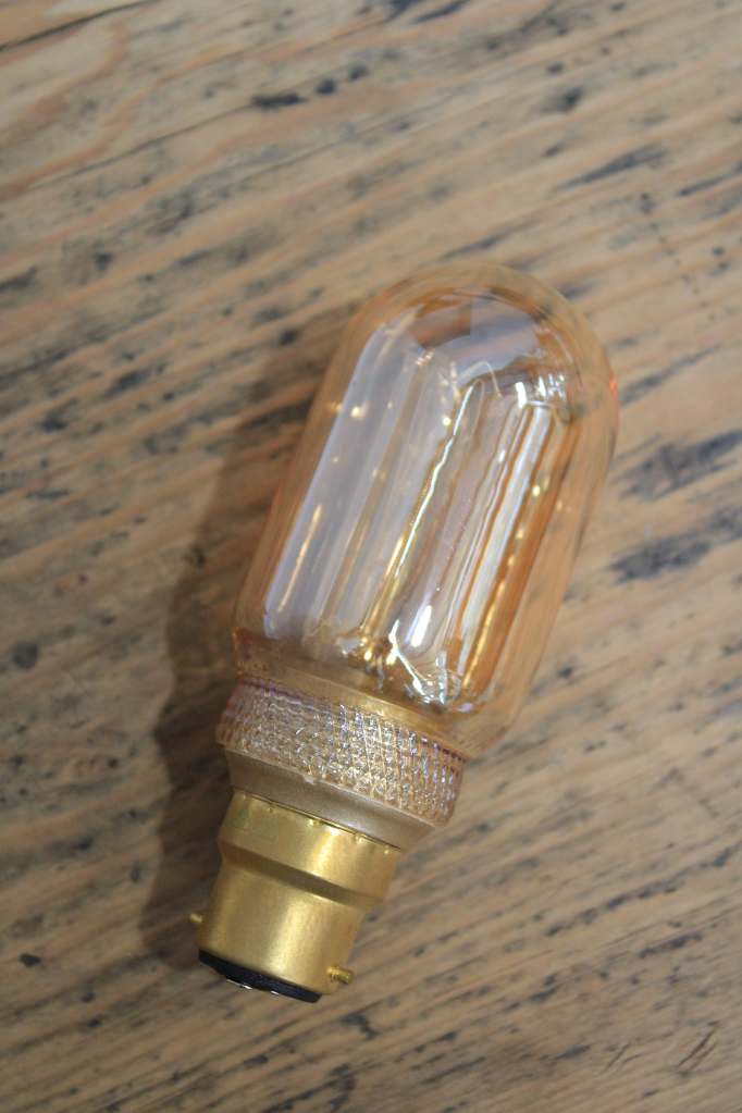 Laser-cut filament amber LED bulb switched off