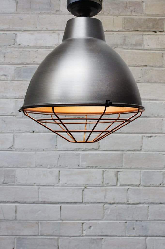 Raw steel loft batten light with antique brass cage guard