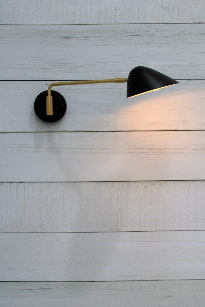 Steel wall light with swivel sconce arm