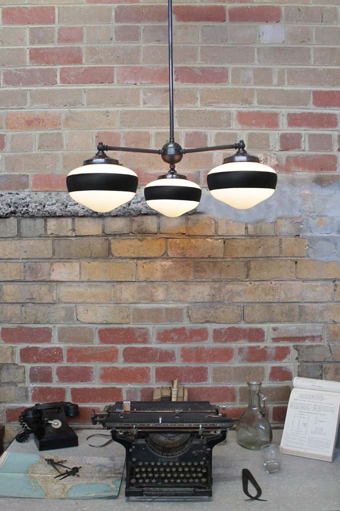 Three light pendant light with one stripe opal shades