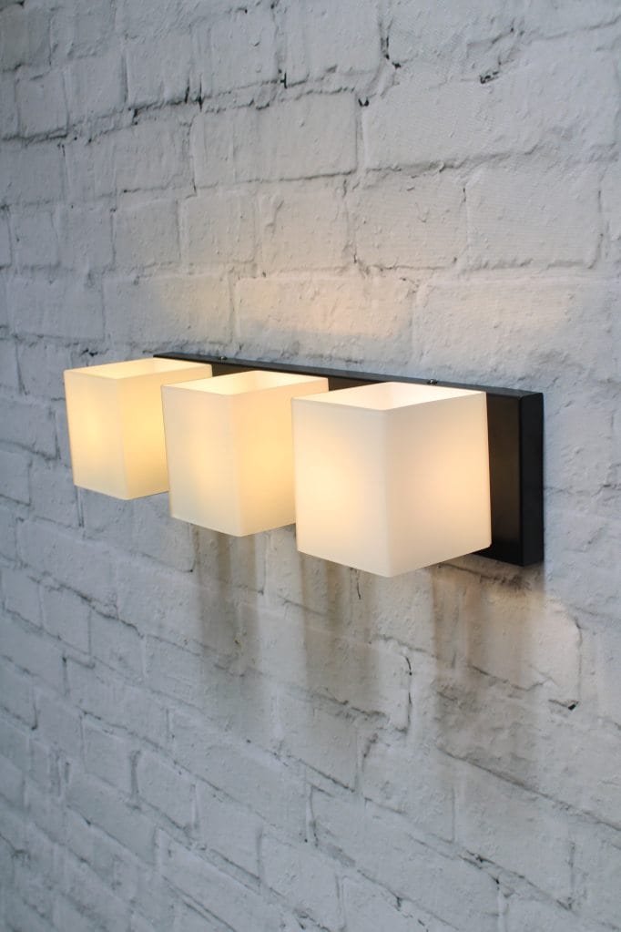 Three light wall light with frosted glass shades and black base