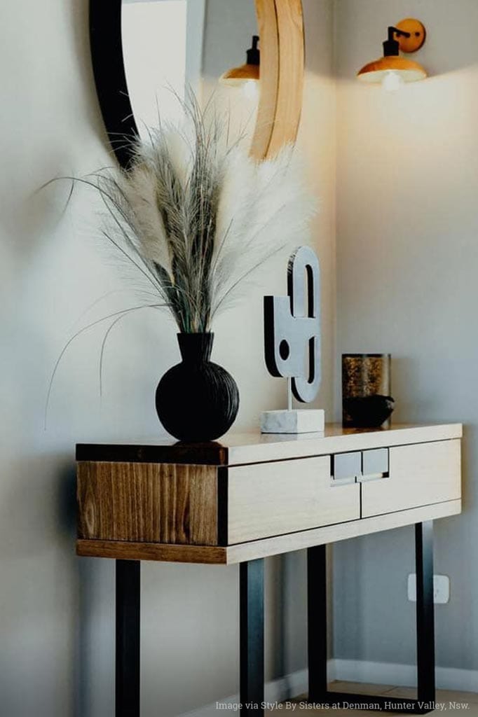 wooden wall light with matt black arm in room