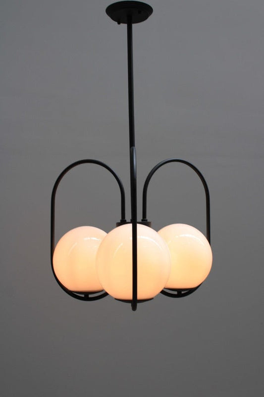 Three light pendant with glass ball shades and black finish metalware