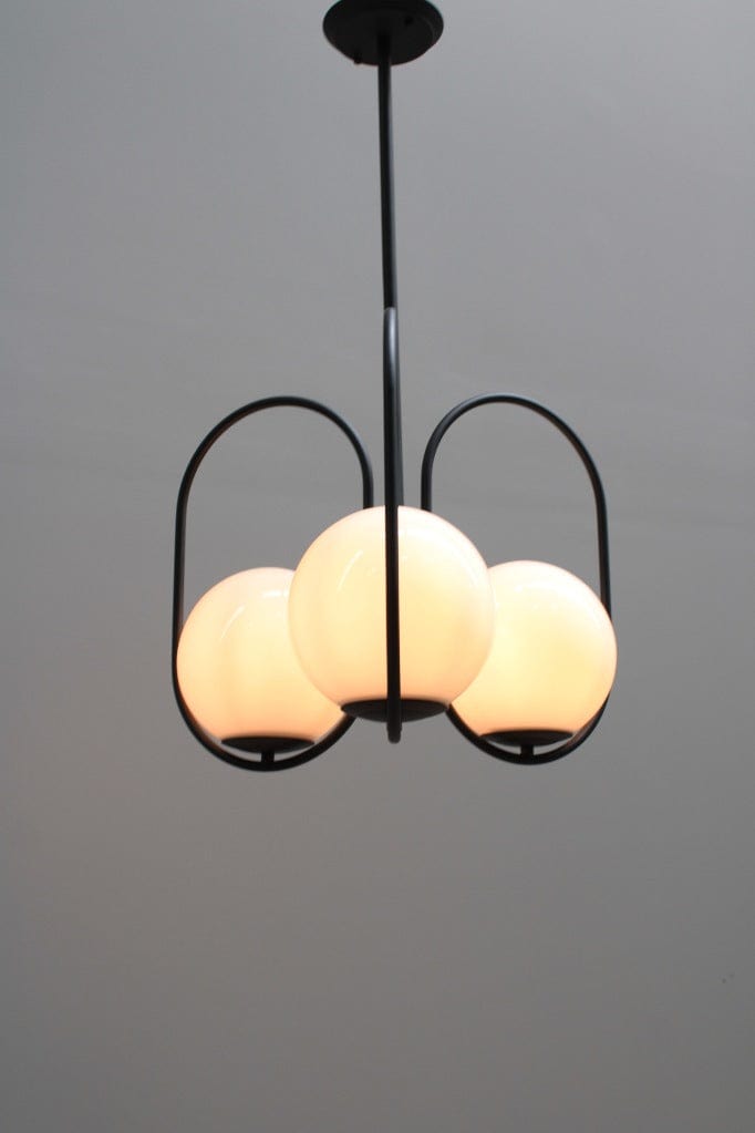 Three light pendant with glass ball shades and black finish metalware