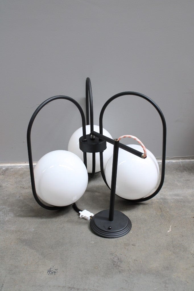 Three light pendant with glass ball shades and black finish metalware