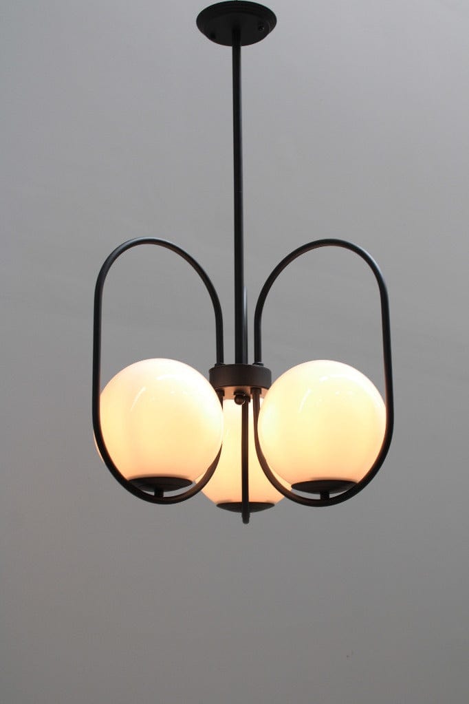 Three light pendant with glass ball shades and black finish metalware