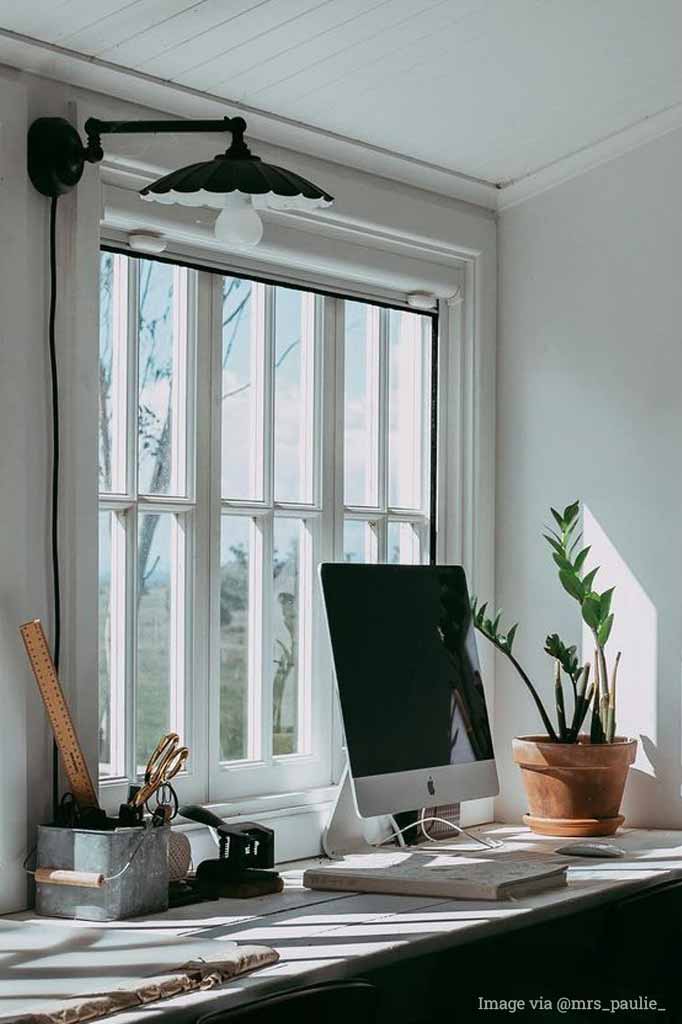 umbrella shade with black steel sconce over a desk .