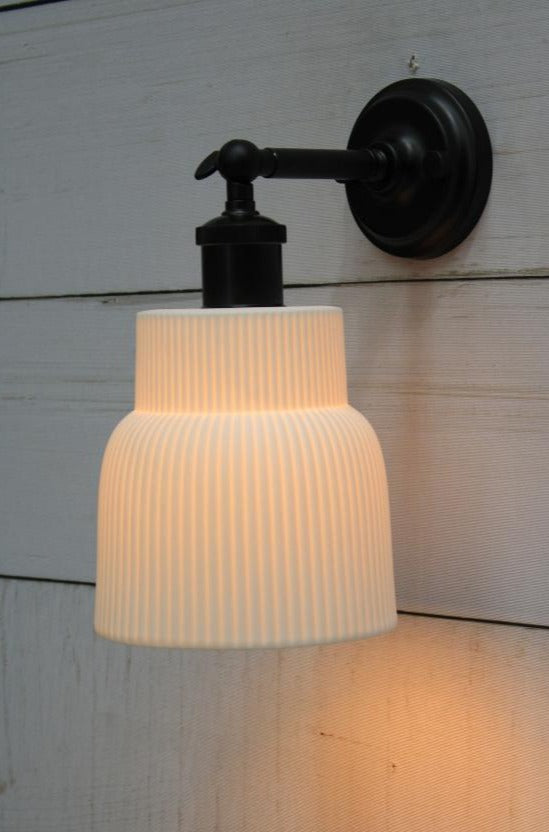 Black wall light with ceramic shade