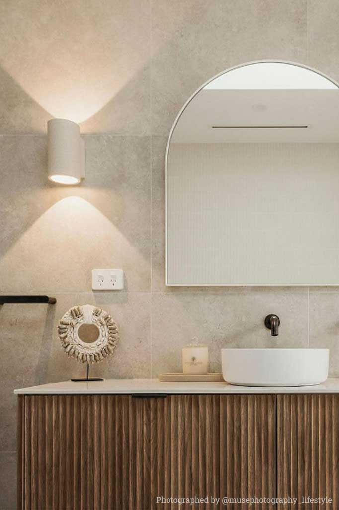 White sandstone wall lights in bathroom.