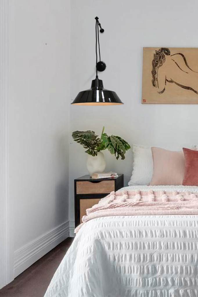 Factory Pulley Wall Light over a bedside table.