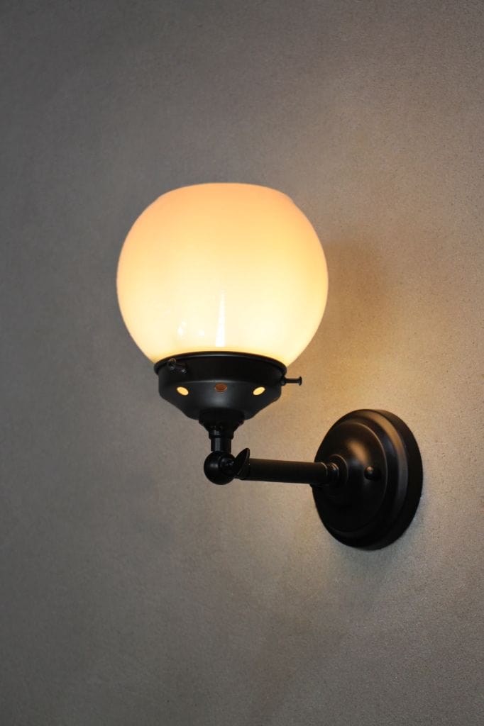 small black wall light with small opal shade in upright configuration