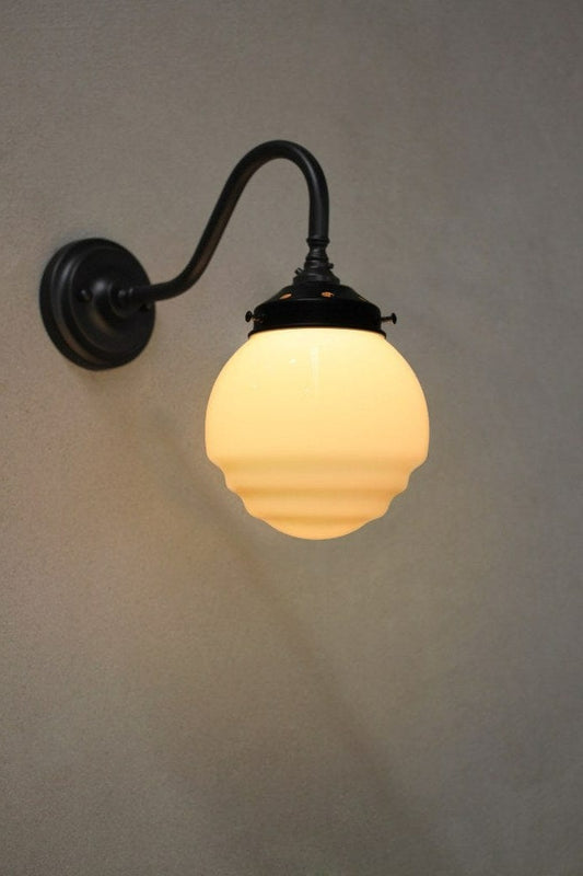 Black wall light with rippled opal shade