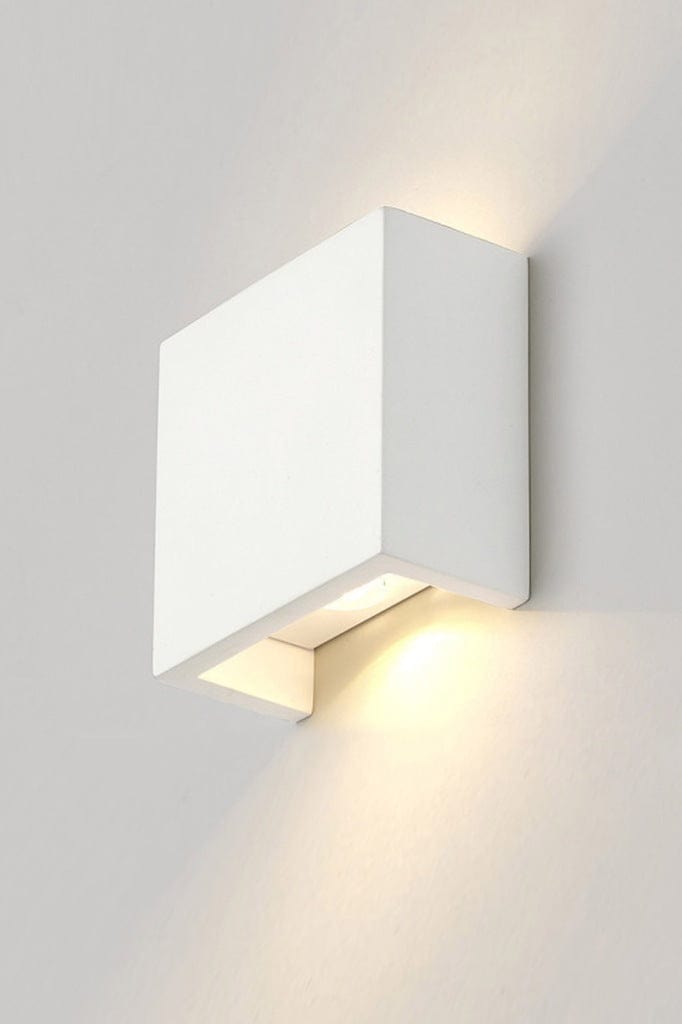 Up and down white rectangular wall light affixed on wall and lit up. 