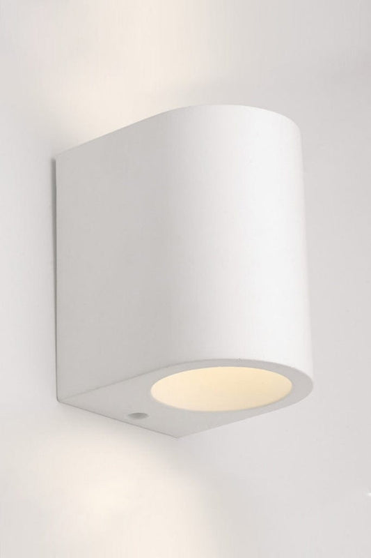 White cylindrical plaster wall light affixed on wall. 