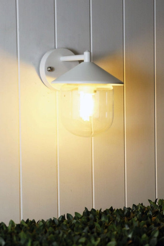 White variant of Cabin Outdoor Wall Light affixed on white wooden panel wall