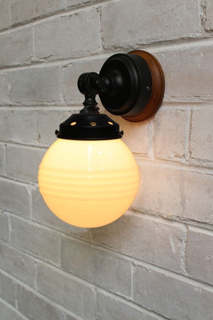 Black swivel wall light with small ridged opal glass shade