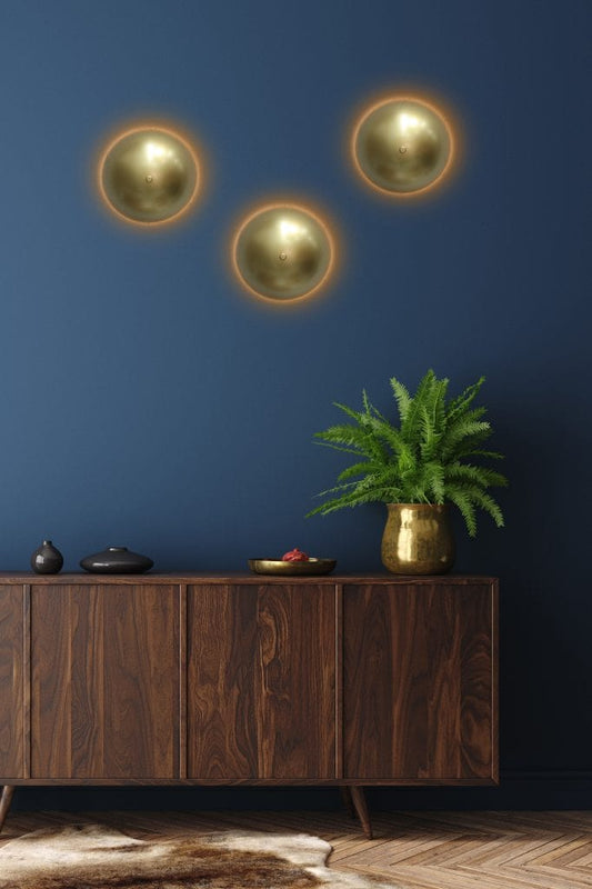 Three gold wall lights in room