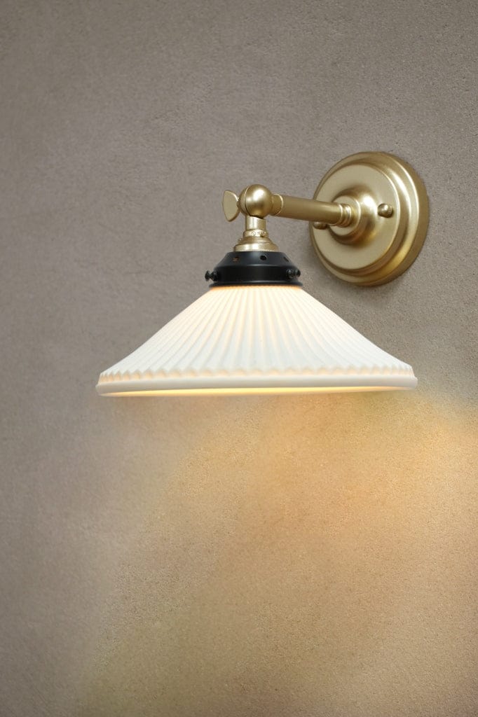 Adjustable wall sconce in gold finish with ceramic shade