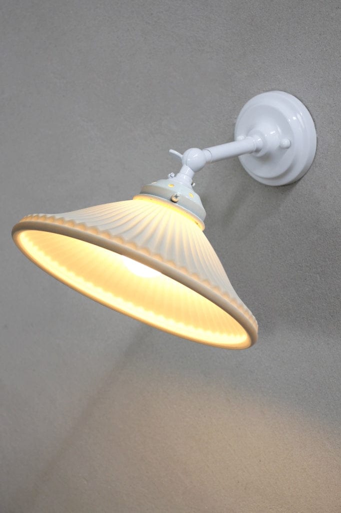 Adjustable wall sconce in white finish with ceramic shade