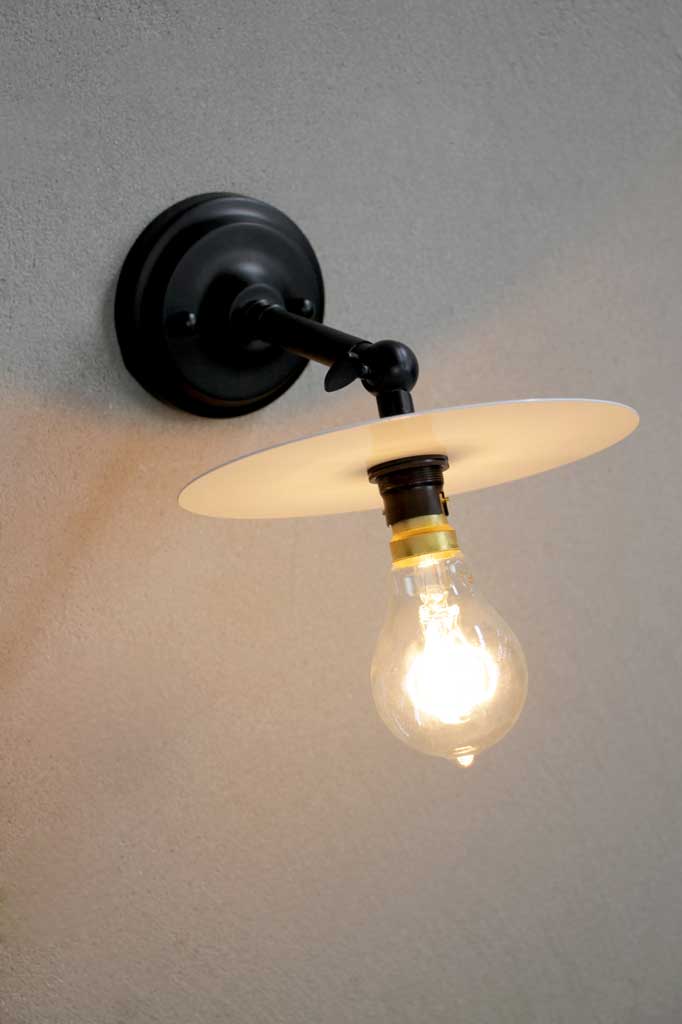 Short adjustable black sconce with white disc