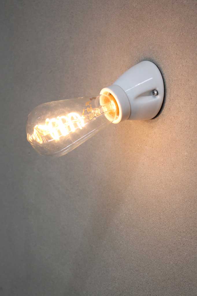 White ceramic batten holder with spiral filament bulb