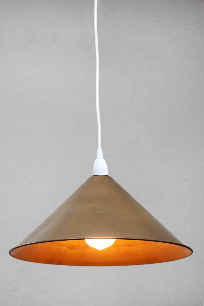 White pendant with brass cone shade