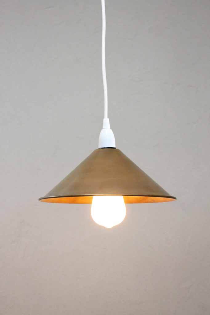 White pendant with brass cone shade