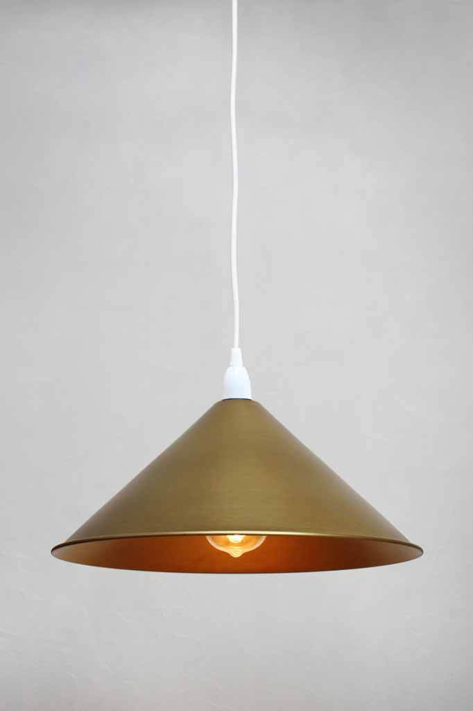 White pendant with brass cone shade