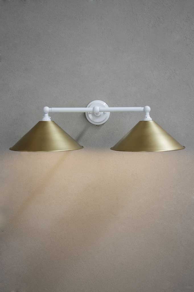 White double arm sconce with bright brass shades