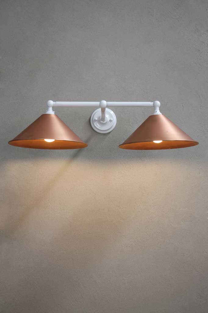 White sconce with bright copper shades