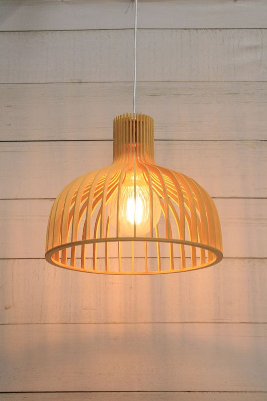 A different angle of the wooden pendant light with white cord on a textured background