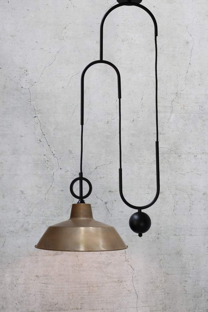 Aged brass factory with black pulley