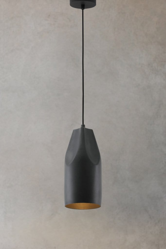 Black metal pendant light with black cord and ceiling rose on concrete background