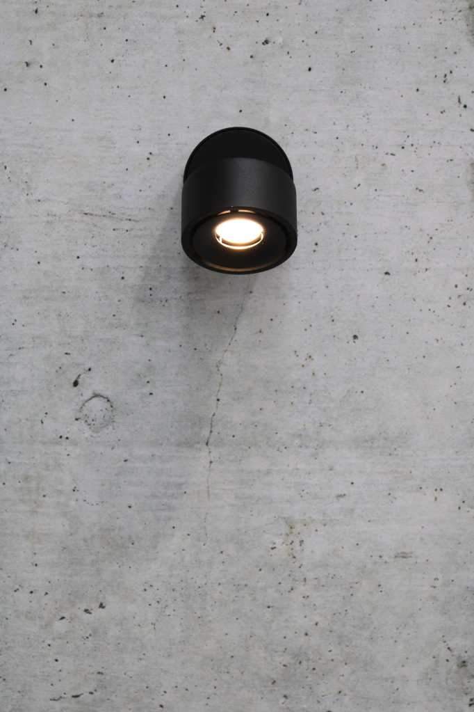 Tiltable black metal wall light