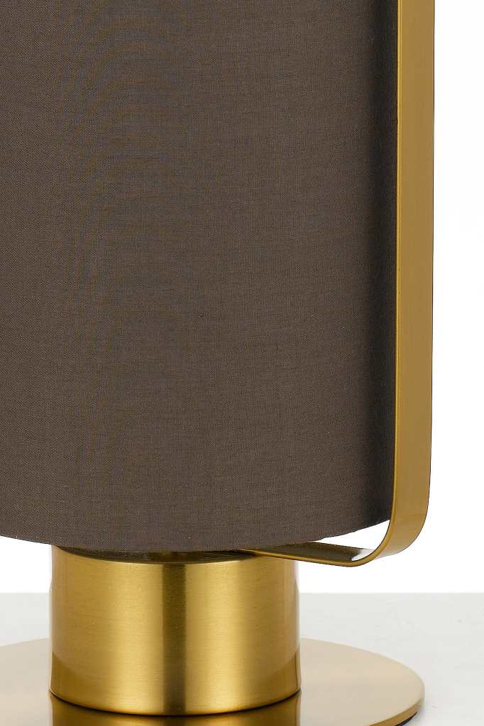 Detail of brown fabric lamp shade with gold brass fixtures