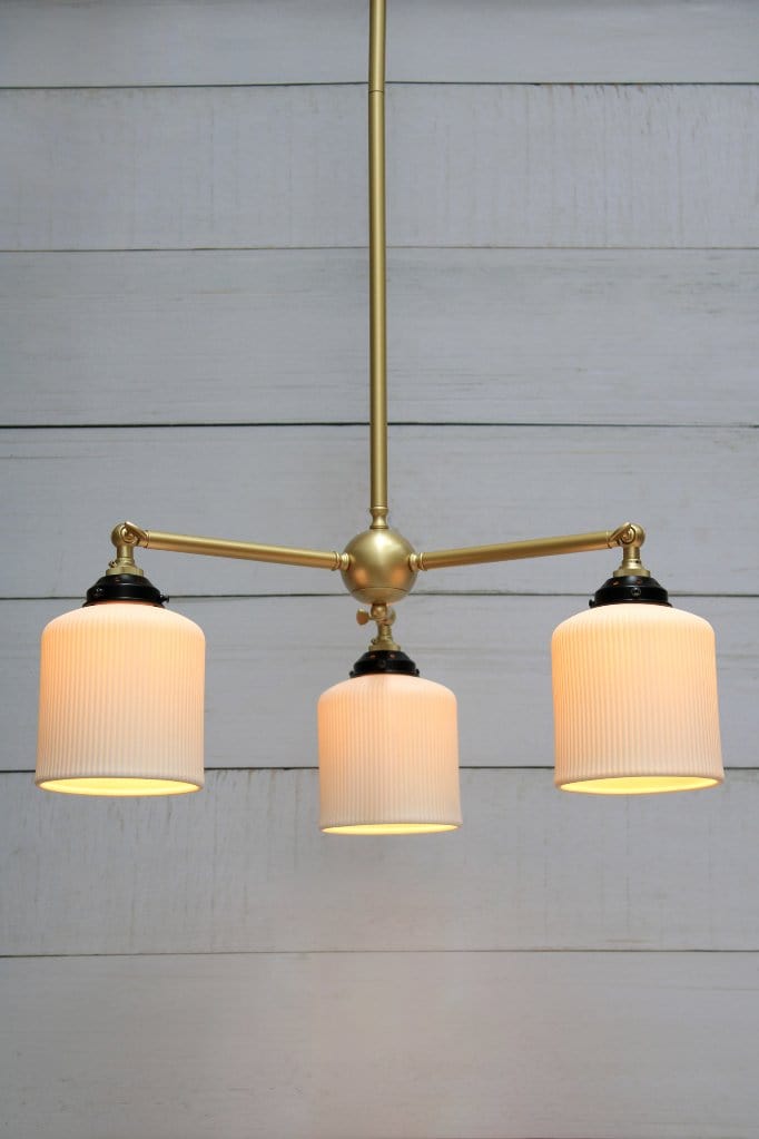 Multi light pendant with gold/brass finish and three ceramic shades