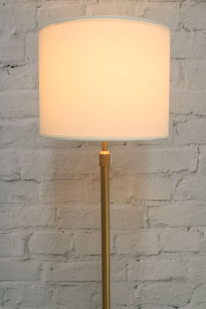 fabric floor lamp in gold finish close up