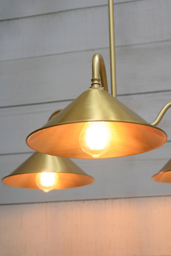 gold base chandelier with bright brass cone shades