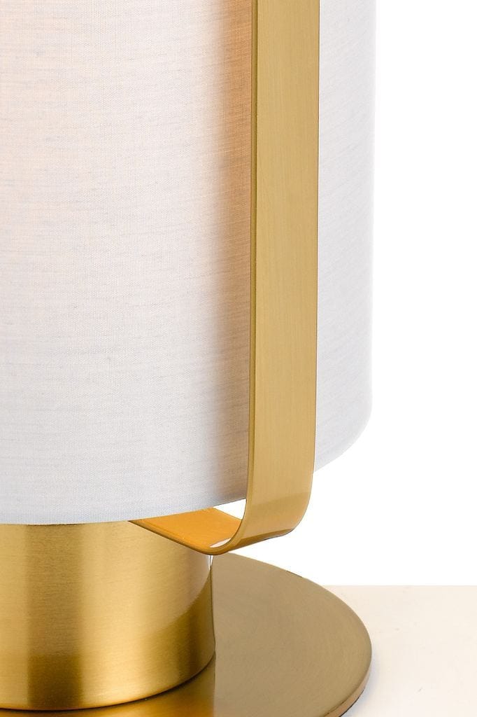 Detail of ivory fabric lamp shade with gold brass fixtures