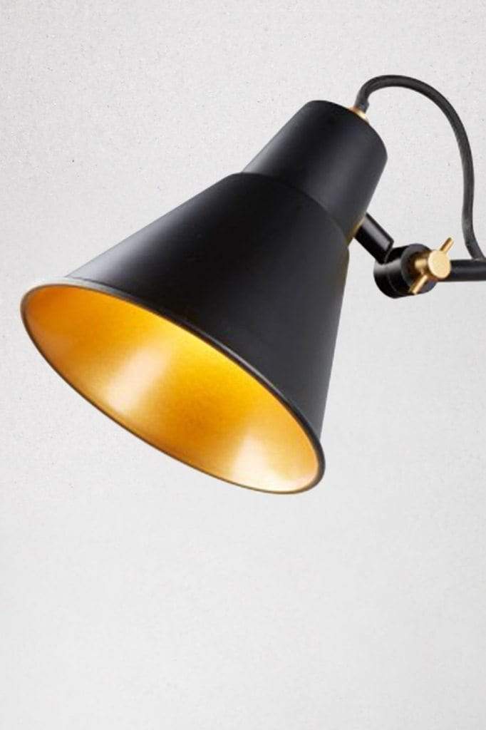 Black metal lamp shade with gold fixtures and shade interior