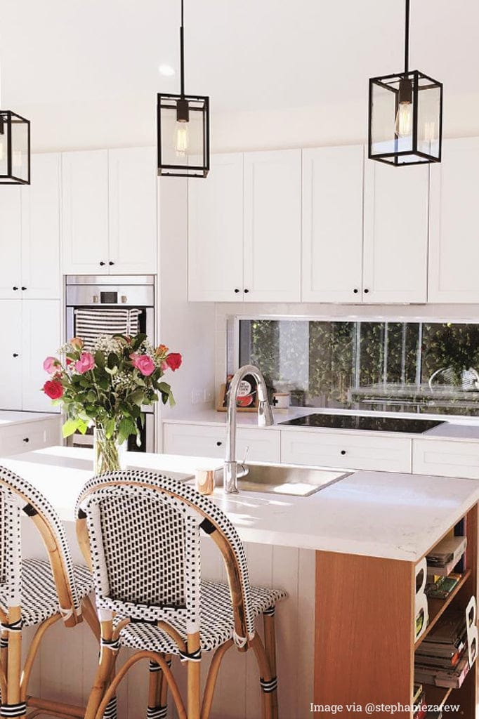 3 Classic black pendant lights over a kitchen island.