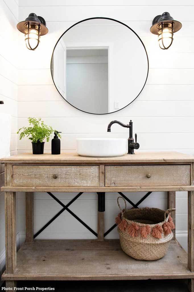 Rustic bathroom renovation with black wall lights