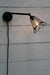 Black swivel wall light with cage