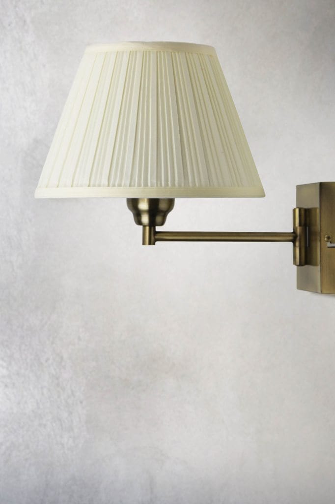 Antique brass wall lamp with pleated fabric shade